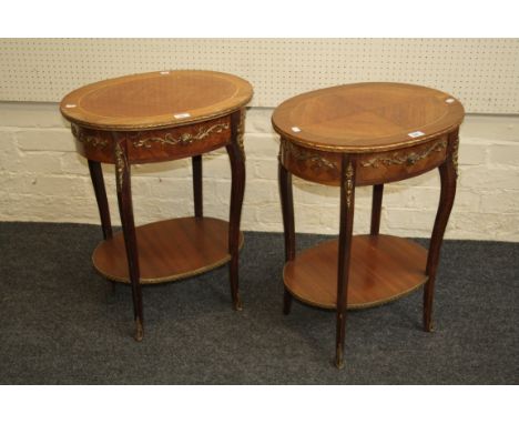 A pair of 18th century French-style kingwood veneer and gilt metal mounted lamp tables, each with oval top above a frieze dra