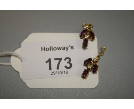 A pair of ruby and diamond five stone pendants One diamond deficient