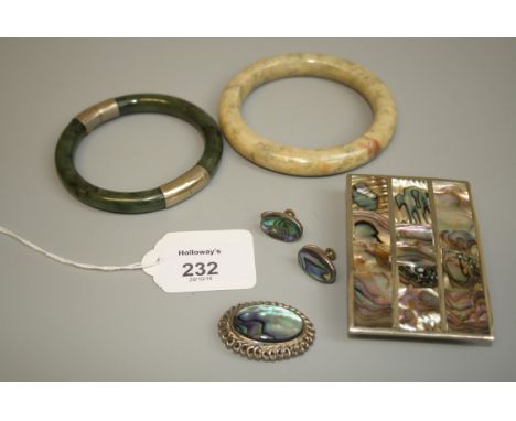 A jade bangle with bamboo engraved yellow metal mounts, together with a mutton fat jade bangle, a mother of pearl panelled be