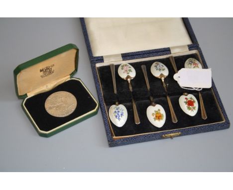 A cased set of silver gilt and enamel teaspoons, the reverse of each bowl with different hand painted flowers over a guilloch