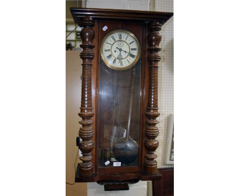 An Edwardian walnut Vienna wall clock, the twin train eight day movement striking on single gong faced by Ivorine Roman and s