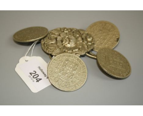 A Portuguese white metal ceremonial cloak clasp, composed of four large coin type fixings to a central foliate plaque