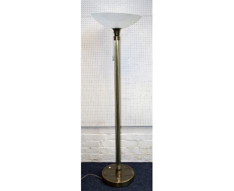 An Art Deco-style uplighter standard lamp, the inverted opaque shade over brass and clear glass tubular column on a mirrored 