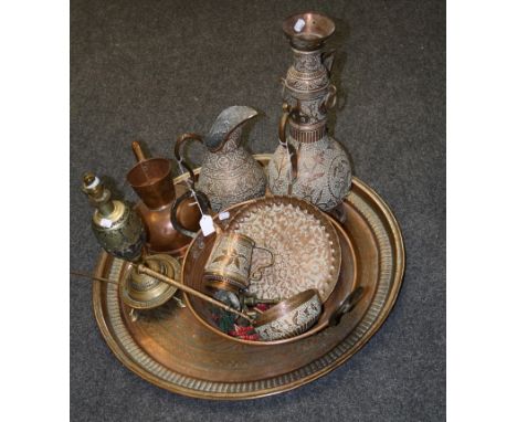 A large early 20th century Middle Eastern copper circular tray, worked with central palm motifs, a water pipe converted to a 