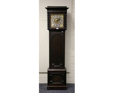 An early 20th century oak longcase clock, the German eight day Westminster chime movement striking on gongs, faced by 11 inch