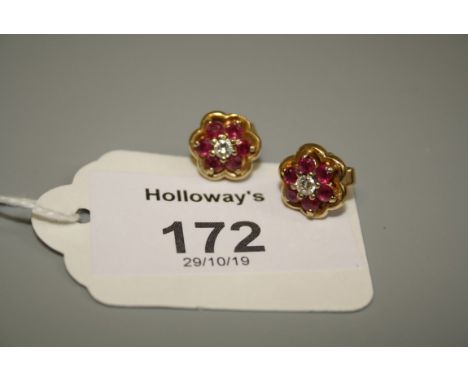 A pair of ruby and diamond cluster earrings, with central brilliant cut diamonds