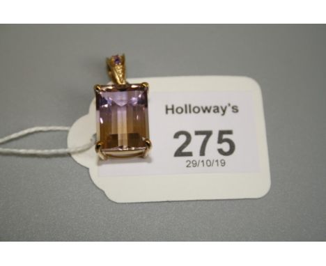 A single stone bi-coloured step cut rectangular citrine pendant, in 9ct gold mount with three stone amethyst bale Gross weigh