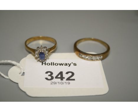 A sapphire and diamond oval cluster ring, to plain 18ct gold shank, together with a five stone, half hoop channel set diamond