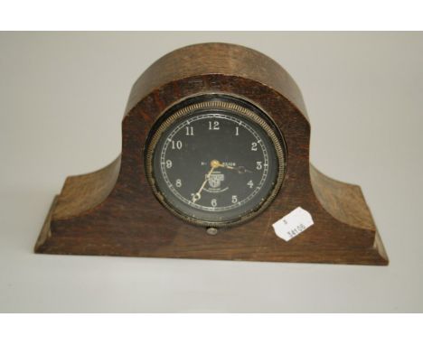 An early 20th century Smiths car dash clock, mounted in an oak ' Napoleon Hat' case, 13.5 x 24cm