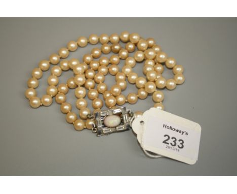 A two row simulated pearl necklace, to a rectangular clasp, set with a central opal, clear and paste stones, mark 9ct