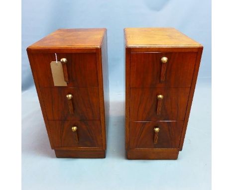 A pair of Art Deco burr walnut pedestal chests, with three drawers, raised on plinth bases, H.68 W.32 D.46cm 