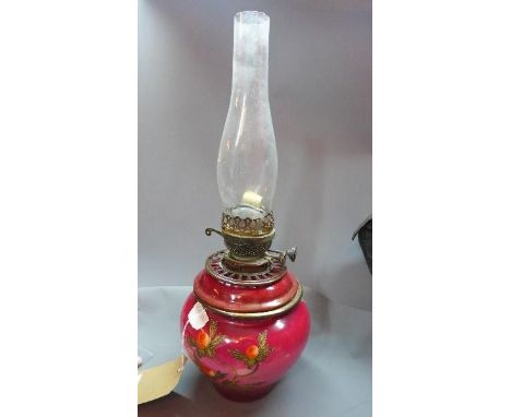 An early 20th century ceramic oil lamp raised on cast metal base, H.56cm (a/f) 