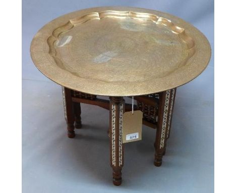 A Moroccan brass topped nomad's table, the base having mother of pearl and bone inlay, H.52 Diameter 59cm 