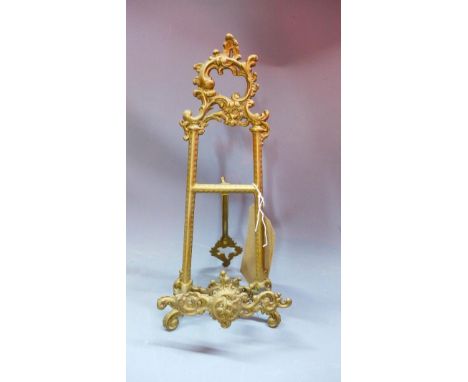 A small brass easel in the Rococo taste, decorated with scrolling foliage, H.34cm 