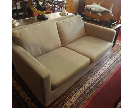 A Contemporary two seater sofa, with blue linen upholstery, raised on tapered legs 