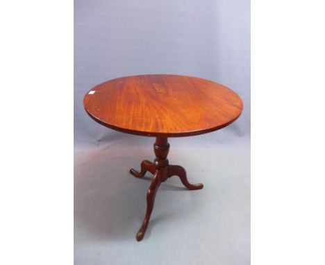 A late 19th century mahogany tilt top wine table, raised on tripod base 