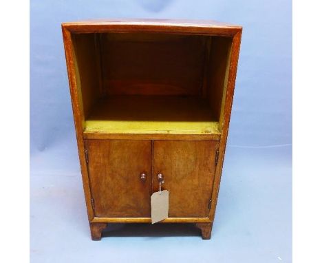 An early 20th century walnut lamp table, with two doors, raised on bracket feet, H.70 W.42 D.34cm 