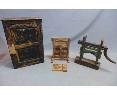 A vintage wall hanging cupboard together with two small wooden doors and a print roller 