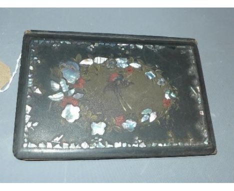 A late 19th / early 20th century papier mache book cover, decorated with a bird to centre within mother of pearl inlay, 23 x 