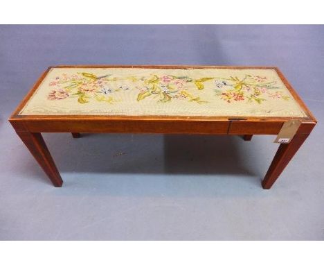 A late 19th century walnut window stool, with tapestry upholstered seat, raised on tapered legs, H.46 W.107 D.38cm 
