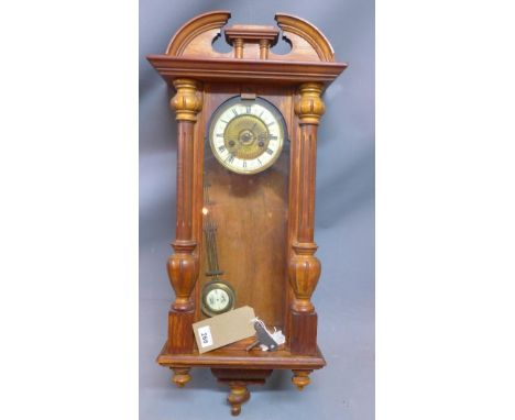 A Vienna regulator style wall clock, the enamel chapter ring with Roman numerals, having gridiron pendulum, the walnut case w