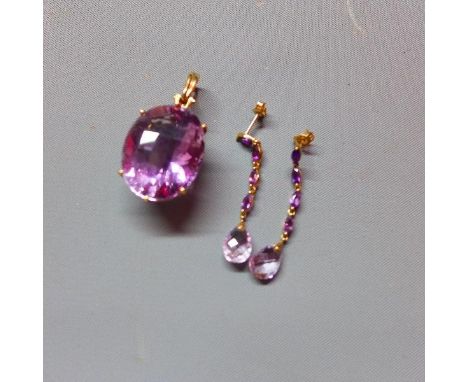 A 9ct yellow gold and amethyst pendant, marked 375, having large oval cut amethyst in pierced 9ct yellow gold mount, together