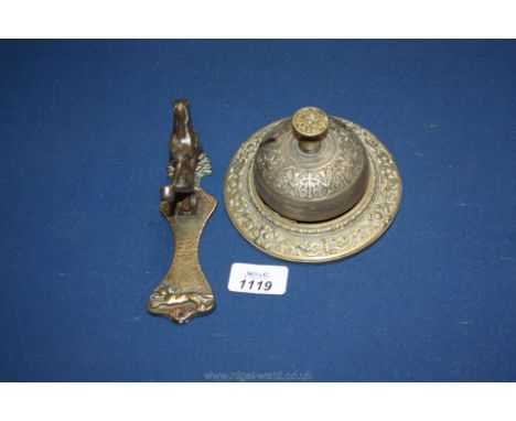 A brass door knocker with a horses head, and a brass reception bell.