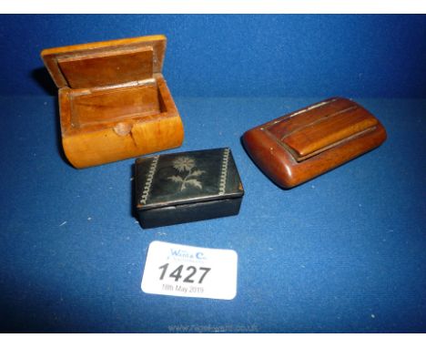 A Boxwood Snuff Box, a Beechwood Snuff Box and a papier mache  Snuff box with inlaid white metal depicting a stylised flower