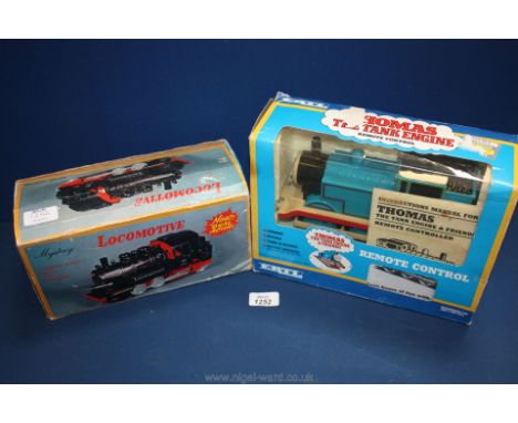 A 'Thomas the Tank Engine' toy, remote control and a battery operated toy Locomotive