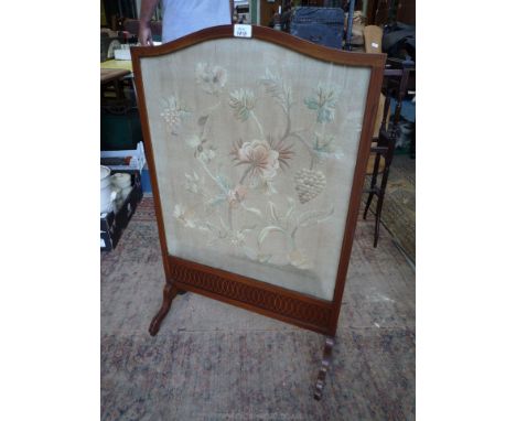 A Mahogany framed Firescreen with lightwood stringing, the panel needlework to portray stylised flowering plants and fruiting