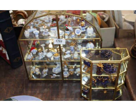 Two miniature display cases and a quantity of blue and white 'Mayfair' collectables including punch bowl, watering can, coffe