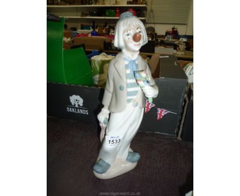 A large vintage model of a Spanish Cascades porcelain clown with a bunch of flowers 12" high.