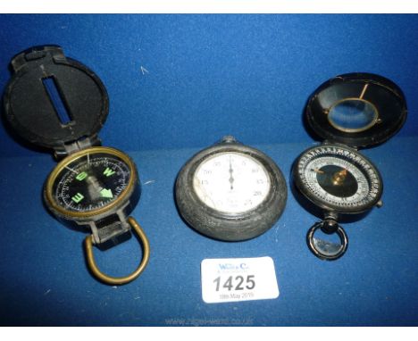 A bakelite cased Engineer directional Compass, a lacquered met cased orienteering Compass with locking button and a rubber cu