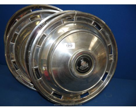 A set of four stainless steel vintage Rover hubcaps with a Viking emblem, 15" diameter.