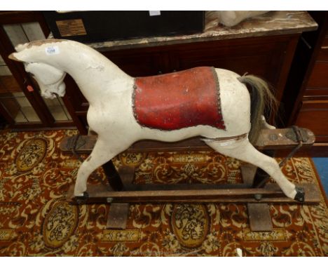 A vintage wood carved Rocking Horse with turned supports on "safety" rocker base, a/f.