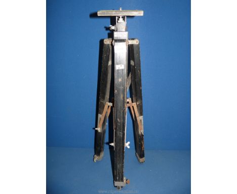 A Gandolfi vintage plate camera tripod in black painted wood with the original maker's nameplate.