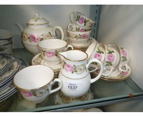 A 20th c. Royal Worcester porcelain tea service decorated with roses comprising cake plate, six side plates and tea cups and 