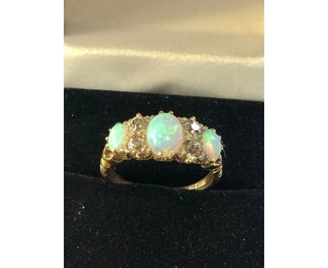 Fine Antique 18ct gold opal and diamond ring set with 3 quality opals largest measures approx 7mm by 5mm  with 2 diamonds eit