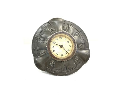 Liberty &amp; Co Tudric pewter desk clock, of circular easel form, with embossed foliate decoration, stamped 0986, clock tick