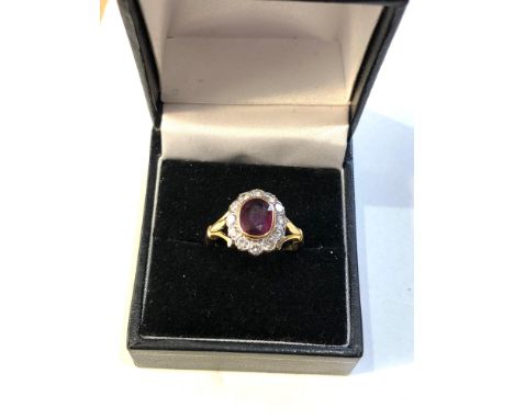 Fine 18ct gold ruby and diamond halo ring set with central ruby 7mm by 6mm with halo of diamonds est .70ct,&nbsp;this ring is