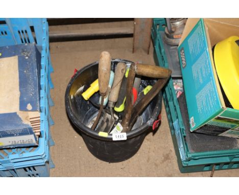 A plastic bucket and contents of gardening tools