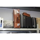 A collection of suitcases and a hat box