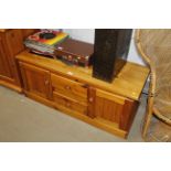A modern pine cupboard fitted two drawers