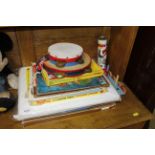 A collection of children's toys, puzzles, two tamb