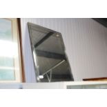 A frameless bevel edged wall mirror