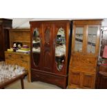 An Edwardian mahogany mirror door wardrobe