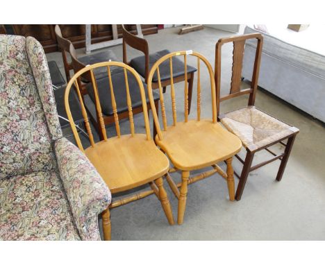 A pair of stick back dining chairs and one other
