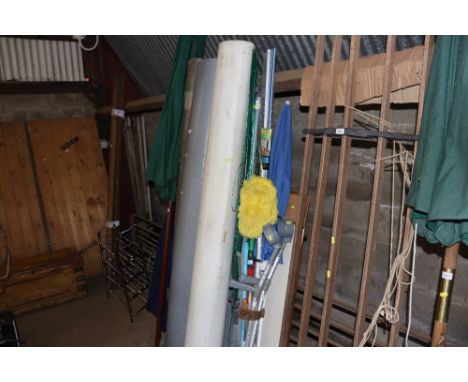 A quantity of various items to include rotary clothes airer, walking sticks, ironing board, parasol etc.