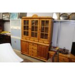 A modern pine and glazed dresser