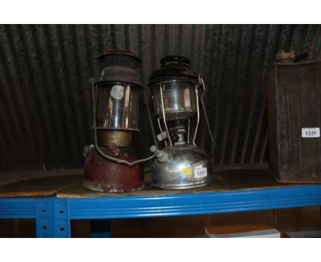 A Bialaddin 300X oil lantern with swing handle and a Tilley lamp with swing handle